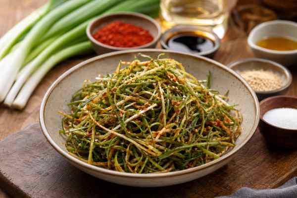 Finished Pajeori Korean Scallion Salad presented in a warm Korean dining setting.