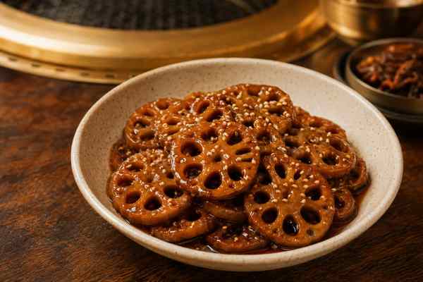 Finished Yeongeun Jorim Soy-Braised Lotus Root presented in a warm Korean dining setting.