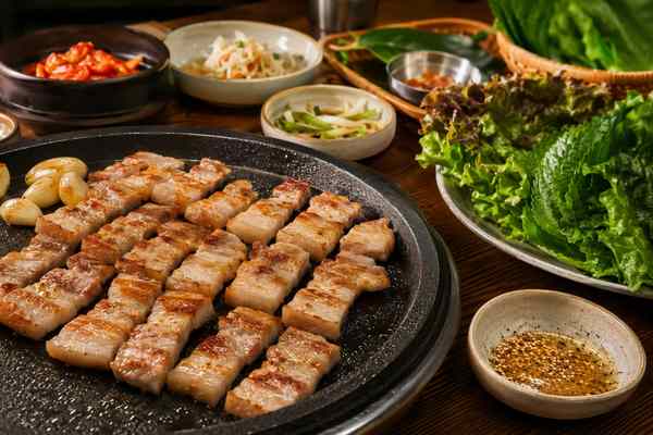 Finished Classic Samgyeopsal with Sesame-Salt Seasoning presented in a warm Korean dining setting.