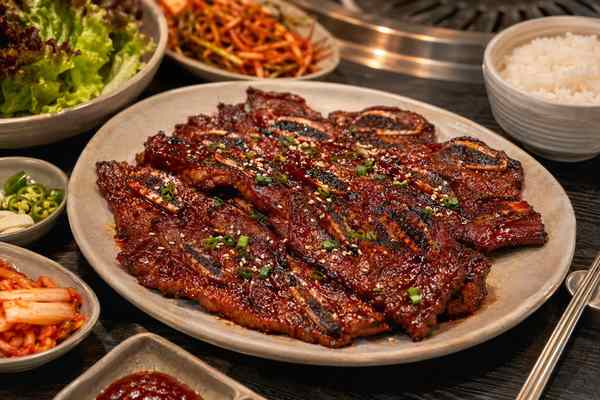 Finished Spicy Gochujang Galbi presented in a warm Korean dining setting.