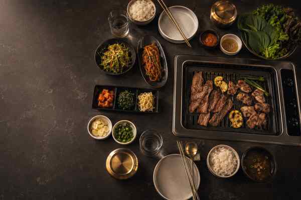 A balanced Korean barbecue menu arranged around a stainless tabletop grill.